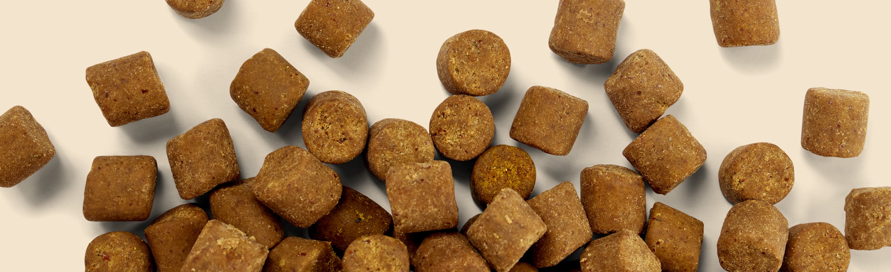 Brown Fera Pets Soft Chews scattered across a light beige background.